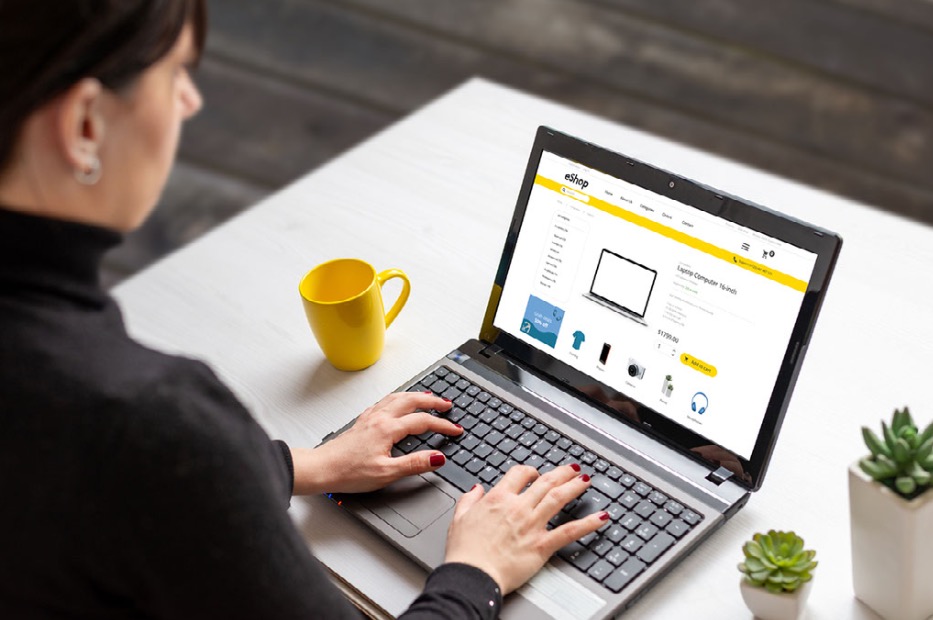 A woman shopping online on a laptop